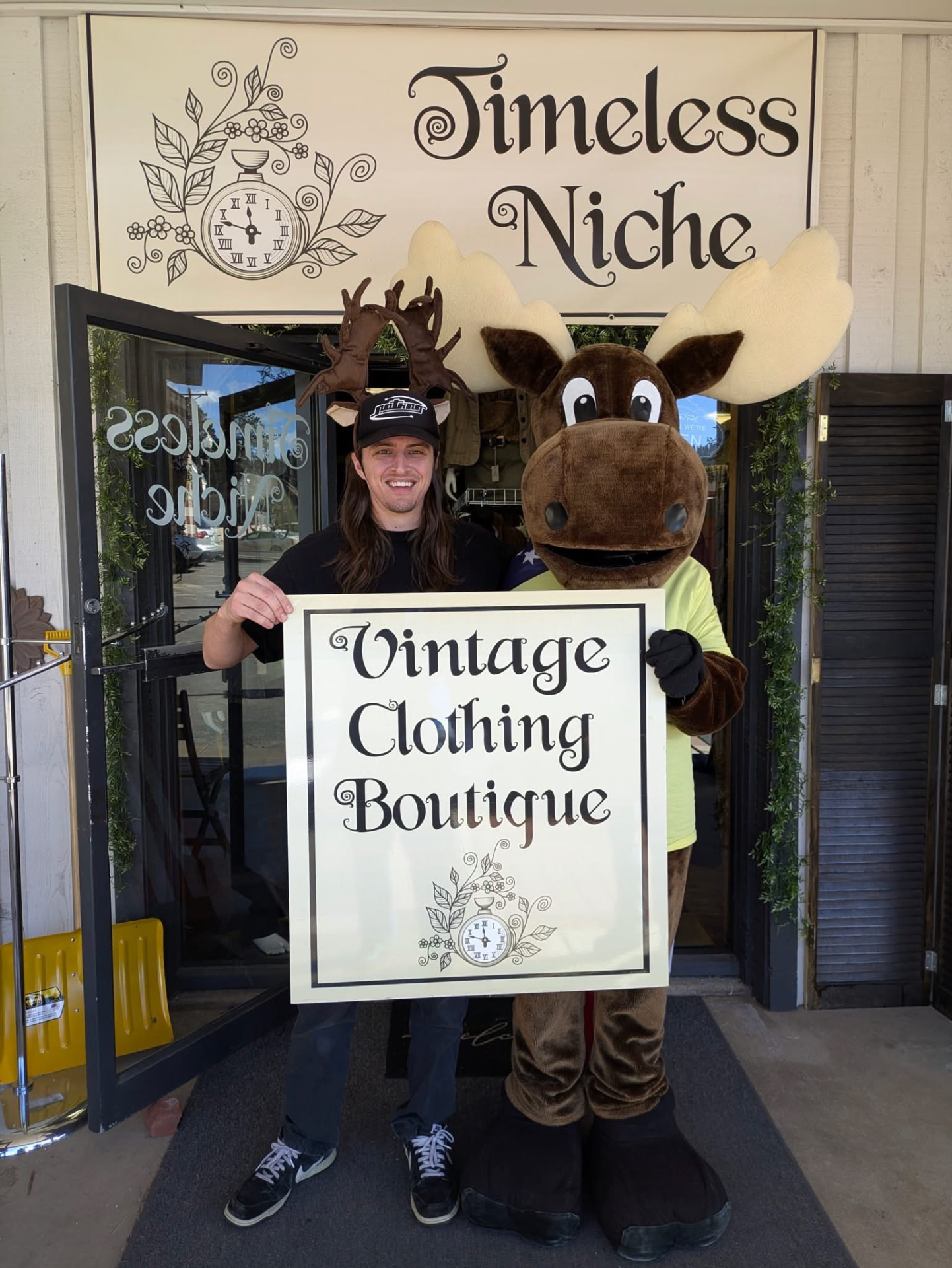 Timeless Niche at a Woodland Park community event with a vintage clothing sign