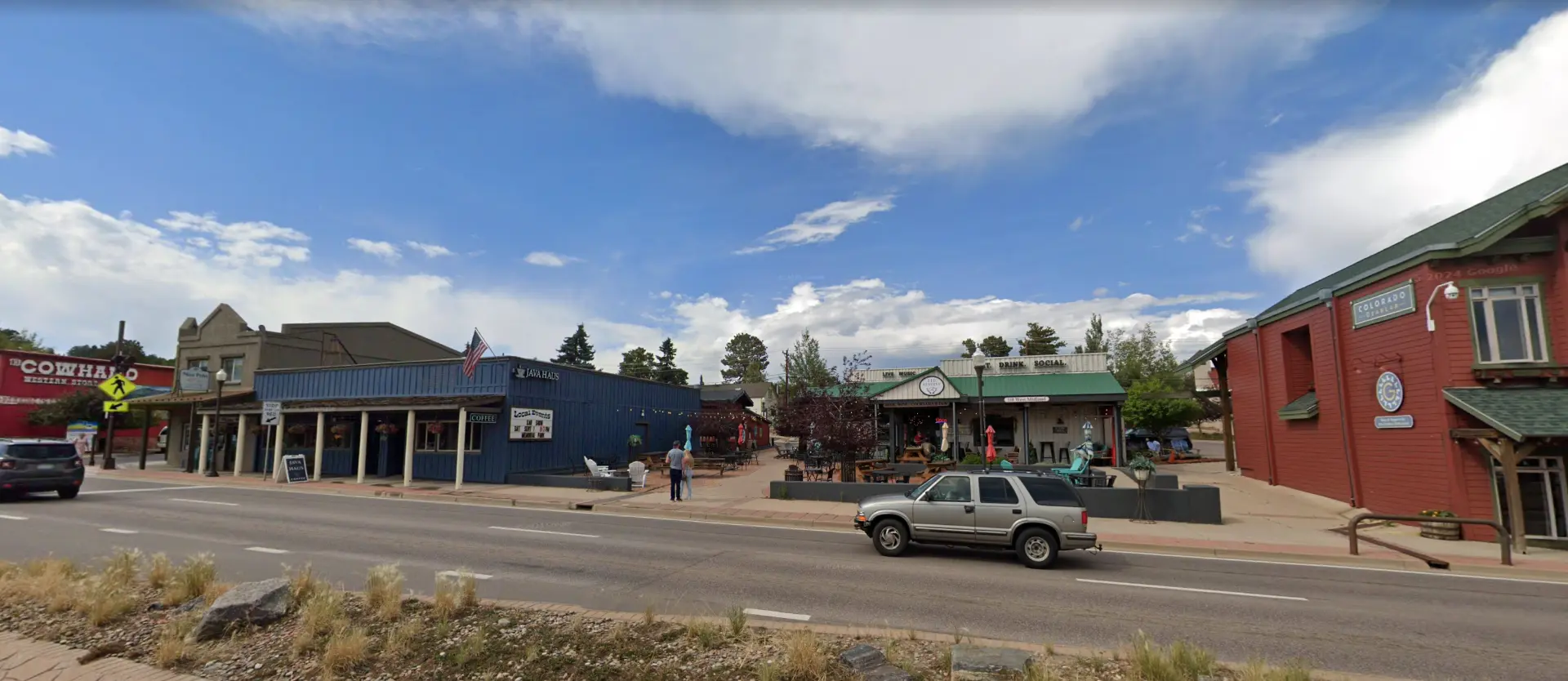 Street-level view of the W Midland Ave block in Woodland Park where Timeless Niche sits